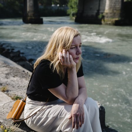 Ingeborg Bachmann (Sandra Hüller) sitzt, nachdenklich auf das Wasser schauend und rauchend, am Ufer des Tiber in Rom.